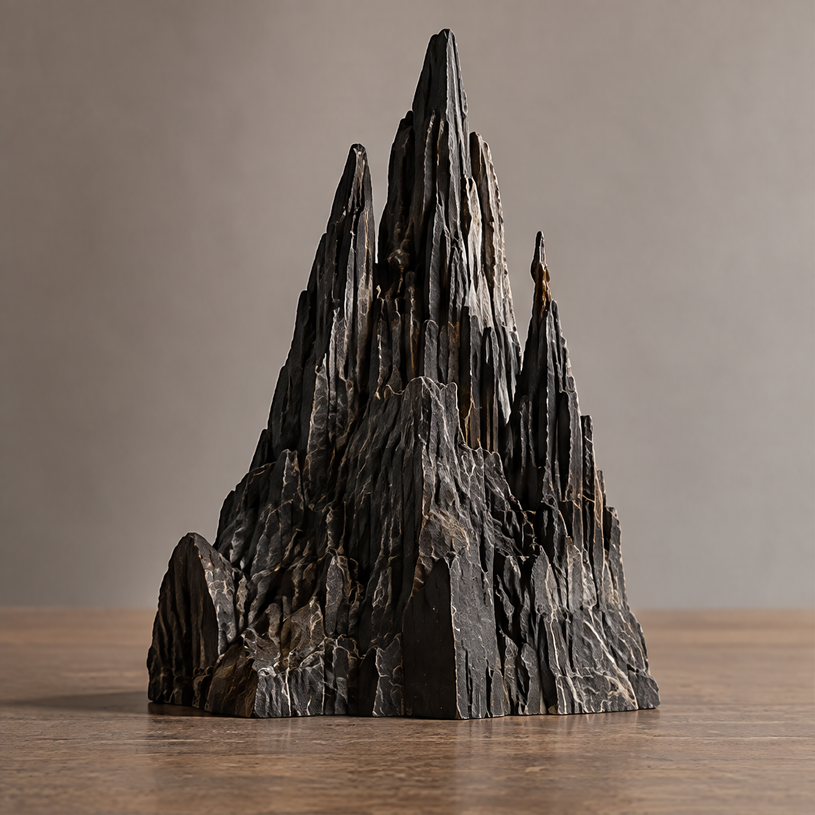 VELMIRN® mountain peak sculpture — front view on wooden surface, dramatic dark stone texture